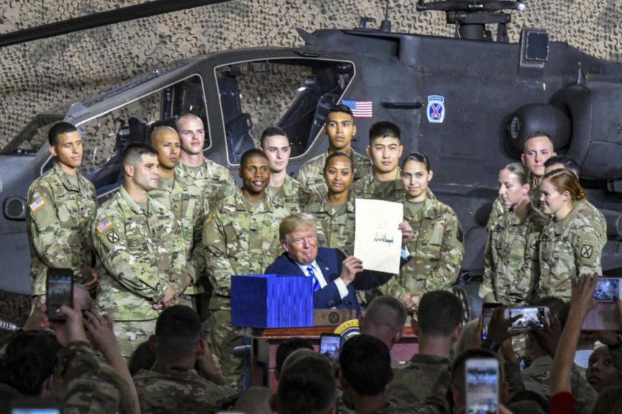 Trump signs the John S. McCain Defense Authorization Act in Fort Drum, New York.