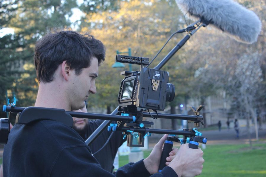 Sac State film production major Dylan Peshek records his peer's senior project at the Library Quad while his friend Matthew Behnam operates the boom microphone on Monday, Feb. 24. Sac State already claims authority to halt any filming that it finds interfering with normal campus operations according to recently implemented policy.