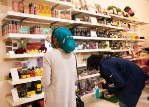 Customers browse the different types of hair and skin care products offered at The Pop Up Shop at Arden on Saturday, Feb. 27 2021. The shop is Black-owned and will offer many cultural products that range from traditional African clothing to hair and skin products to casual wear and jewelry.
