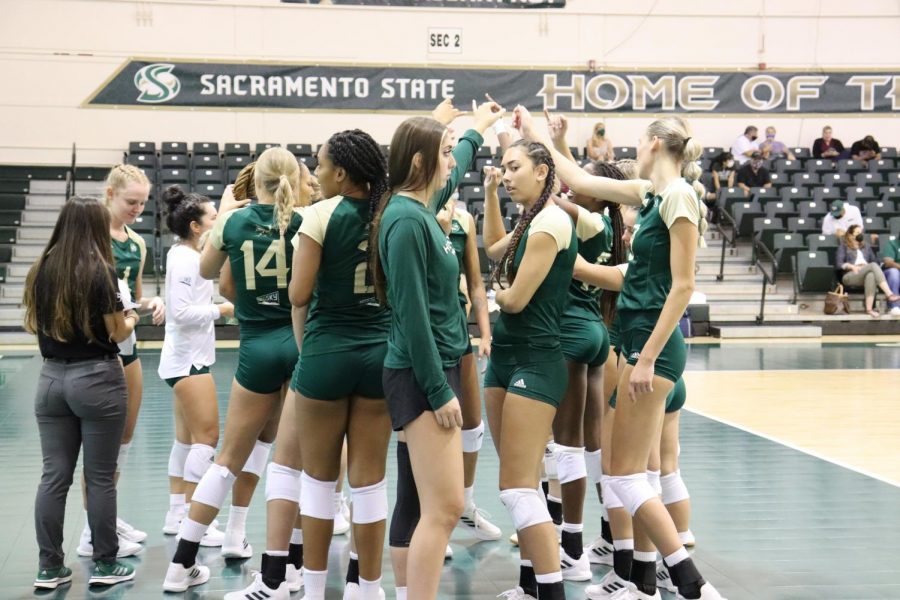 The Sacramento State women’s volleyball team huddles with their stingers up during a timeout in a game against CSU Northridge in the Sacramento State invitational tournament on Sept. 10, 2021. The team lost both of their first Big Sky conference games over the weekend, 2-3 in the first match against Idaho State and 1-3 in its match against Weber State.