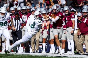 Sac State freshman linebacker Mitchell Wolfe (58) gets stiff-armed as he attempts to tackle Montana sophomore safety Garrett Graves (5) on Oct. 16, 2021, at Washington-Grizzly Stadium. The Hornets pulled off the upset and beat the #5 ranked Grizzlies for the first time in Missoula by a score of 28-21. 