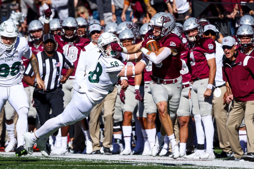 Sac State freshman linebacker Mitchell Wolfe (58) gets stiff-armed as he attempts to tackle Montana sophomore safety Garrett Graves (5) on Oct. 16, 2021, at Washington-Grizzly Stadium. The Hornets pulled off the upset and beat the #5 ranked Grizzlies for the first time in Missoula by a score of 28-21.