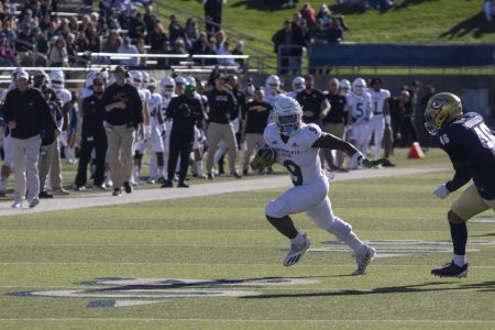 Sophomore running back Marcus Fulcher (9) finds the edge versus UC Davis’ sophomore linebacker Calvin Mouisset (46) for a first down on November 20th 2021at UC Davis Health Stadium.The Hornets will face-off against the Jackrabbits for their most important game of the season on Saturday at Hornet Stadium.