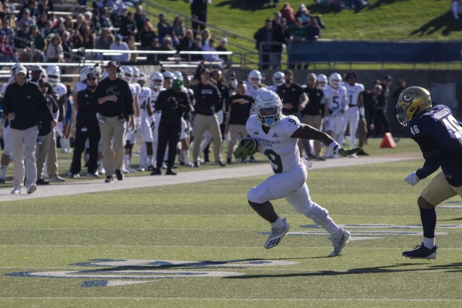 Sophomore running back Marcus Fulcher (9) finds the edge versus UC Davis’ sophomore linebacker Calvin Mouisset (46) for a first down on November 20th 2021at UC Davis Health Stadium.The Hornets will face-off against the Jackrabbits for their most important game of the season on Saturday at Hornet Stadium.