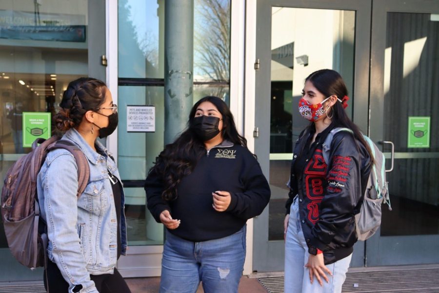 Dulce López, a senior nutrition major (left), Gabriela Camargo, a senior communications and Spanish major (middle), and Izabelle Lerma, a senior business major (right), talk in front of the University Union on Monday, Feb. 7, 2022. Sac State students have differing opinions on being back on campus, but the return to in-person instruction mandates many of them to return regardless. 