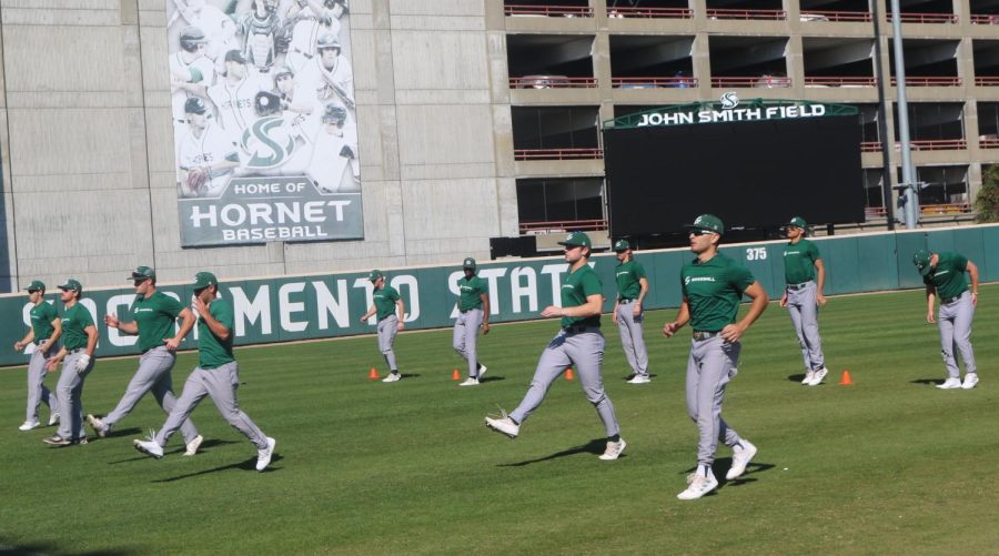 Sac State's baseball team warms up before a practice Feb.17 in front of the Hornets' brand new scoreboard."The new scoreboard is something we've been working for, fundraising and just playing our hearts out on the field for everybody." said senior pitcher Brady Rodriguez.
