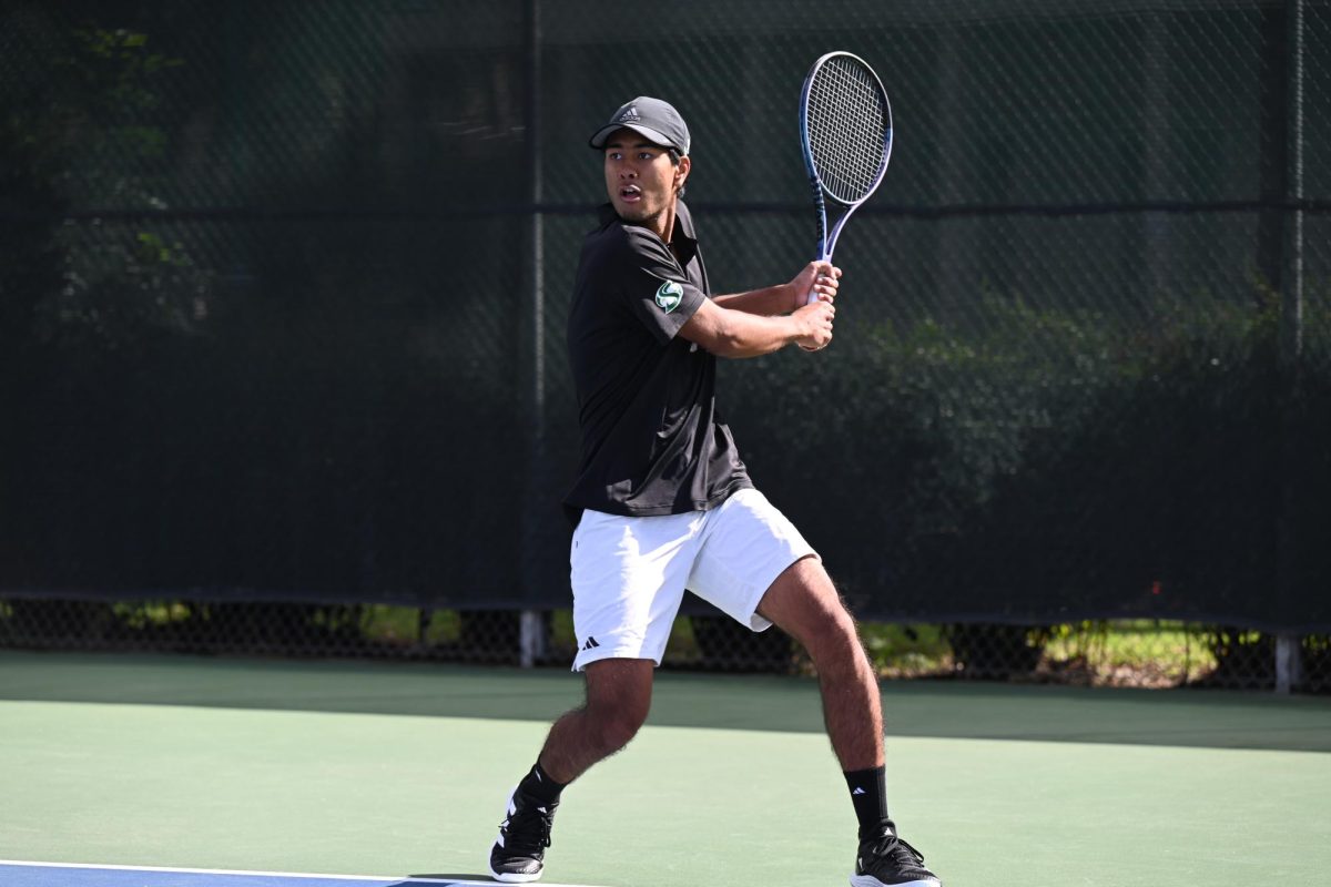 Sophomore Henry Lamchinniah returns with a backhand swing against UC Davis Friday, Feb. 14, 2025. Lamchinniah went on to lose the singles match at first, and the Hornets lost 1-4 against the Aggies.